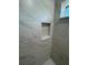 This shower features a marble-look tile surround and built-in niche at 14415 Sw 21St Pl, Ocala, FL 34481