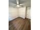 Nicely finished bedroom with wood look floors and a ceiling fan at 14415 Sw 21St Pl, Ocala, FL 34481