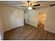 Spacious bedroom featuring wood floors, ceiling fan, and an en suite bathroom at 14415 Sw 21St Pl, Ocala, FL 34481