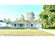 Charming single-story home with a manicured lawn and attached one car garage at 14415 Sw 21St Pl, Ocala, FL 34481