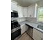 Updated kitchen with granite countertops, stainless steel appliances, and modern white cabinets at 14415 Sw 21St Pl, Ocala, FL 34481