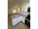 Kitchen island with granite countertops, white cabinets, and stainless steel appliances at 14415 Sw 21St Pl, Ocala, FL 34481