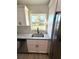 Stainless steel kitchen sink featuring granite countertops and subway tile backsplash at 14415 Sw 21St Pl, Ocala, FL 34481
