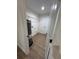 The laundry room features a water heater, wire shelving, and light colored walls at 14415 Sw 21St Pl, Ocala, FL 34481