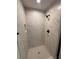 Walk-in shower featuring custom tile and updated fixtures at 14415 Sw 21St Pl, Ocala, FL 34481