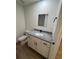 Bathroom features a white vanity with granite countertop, white toilet and mirror at 14425 Sw 21St Pl, Ocala, FL 34481