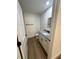 Bathroom with granite countertops, modern hardware, and wood-look flooring at 14425 Sw 21St Pl, Ocala, FL 34481
