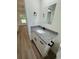 Bathroom features a white vanity with granite counters, black hardware, and modern sink at 14425 Sw 21St Pl, Ocala, FL 34481
