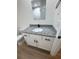 Bathroom features a white vanity with a granite countertop and black fixtures at 14425 Sw 21St Pl, Ocala, FL 34481