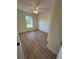 Bright bedroom features sleek wood-look floors and a window view of the outdoors at 14425 Sw 21St Pl, Ocala, FL 34481