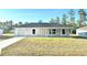 Charming single-story home featuring a well-manicured lawn, attached garage, and neutral exterior paint at 14425 Sw 21St Pl, Ocala, FL 34481
