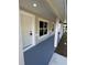 The front porch offers a welcoming view with freshly painted floors, pillars, and neutral walls at 14425 Sw 21St Pl, Ocala, FL 34481