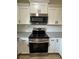 Modern kitchen features stainless steel appliances, white cabinets, granite countertops, and stylish backsplash at 14425 Sw 21St Pl, Ocala, FL 34481