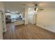Open-concept living space featuring hardwood flooring, white walls, and an updated kitchen with stainless appliances at 14425 Sw 21St Pl, Ocala, FL 34481
