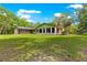 Expansive backyard featuring well-maintained lawn, screened porch, and mature trees at 17150 Se 168Th Ter, Weirsdale, FL 32195