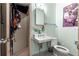 Compact bathroom with a pedestal sink, toilet, and mirrored medicine cabinet at 17150 Se 168Th Ter, Weirsdale, FL 32195