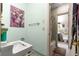 Compact bathroom with a sink, toilet, walk-in shower and tile flooring at 17150 Se 168Th Ter, Weirsdale, FL 32195