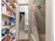 Small bathroom with tile flooring, a shower with curtain, and built-in shelving at 17150 Se 168Th Ter, Weirsdale, FL 32195