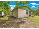 Exterior corner view of the home with an adjacent detached guest house and green foliage at 17150 Se 168Th Ter, Weirsdale, FL 32195