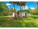 Side exterior view of home with brick facade, palm trees, and a well-kept lawn at 17150 Se 168Th Ter, Weirsdale, FL 32195