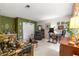 Bright living room featuring a patterned sofa, recliner, and a large window at 17150 Se 168Th Ter, Weirsdale, FL 32195