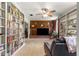 Cozy living room featuring a brick fireplace, built-in bookshelves, and wood paneled accent wall at 17150 Se 168Th Ter, Weirsdale, FL 32195