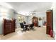 Traditional home office with wooden furniture, a ceiling fan, and natural light from the window at 17150 Se 168Th Ter, Weirsdale, FL 32195