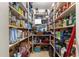Walk-in pantry stocked with groceries, household items and ample shelving for organized storage at 17150 Se 168Th Ter, Weirsdale, FL 32195