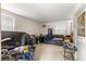 Untidy storage area with a sofa, work desk, and shelving. Needs organization and cleaning at 17150 Se 168Th Ter, Weirsdale, FL 32195