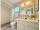 Bathroom featuring a vanity, sink, mirror and a shower with neutral decor at 17574 Se 95Th Ct, Summerfield, FL 34491