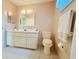 Bathroom featuring a vanity, sink, mirror and toilet at 17574 Se 95Th Ct, Summerfield, FL 34491