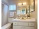 Bathroom features a vanity, sink, mirror and toilet with neutral decor at 17574 Se 95Th Ct, Summerfield, FL 34491