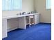 Bedroom with built-in desk, drawers, stool and blue carpet at 17574 Se 95Th Ct, Summerfield, FL 34491