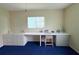 Bedroom featuring a long built-in desk, cabinets, a stool and blue carpet at 17574 Se 95Th Ct, Summerfield, FL 34491