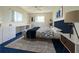 Stylish bedroom with modern bed frame, area rug and blue accents at 17574 Se 95Th Ct, Summerfield, FL 34491