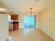 Cozy dining area featuring stylish lighting, tile floors and access to kitchen and outdoor space at 17574 Se 95Th Ct, Summerfield, FL 34491