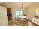 Bright dining area with modern chandelier and view of the backyard at 17574 Se 95Th Ct, Summerfield, FL 34491