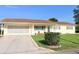 Charming single-story home featuring a well-maintained front yard and attached two-car garage at 17574 Se 95Th Ct, Summerfield, FL 34491
