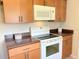 Well-lit kitchen with essential appliances and practical design at 17574 Se 95Th Ct, Summerfield, FL 34491