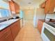 Bright eat-in kitchen features wood cabinets and tile floor at 17574 Se 95Th Ct, Summerfield, FL 34491