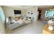 Open concept living room featuring modern furniture, decorative art, and a view to the kitchen at 17574 Se 95Th Ct, Summerfield, FL 34491