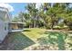 Expansive backyard with lush greenery and mature trees, perfect for outdoor enjoyment and relaxation at 1812 Se 38Th Ave, Ocala, FL 34471