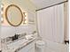 Bathroom featuring shower-tub combo, toilet, vanity with mirror and patterned wallpaper at 1812 Se 38Th Ave, Ocala, FL 34471
