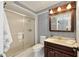 Bathroom featuring shower, toilet, vanity and patterned wallpaper at 1812 Se 38Th Ave, Ocala, FL 34471