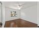 Bright bedroom features hardwood floors, ceiling fan, and a window with views at 1812 Se 38Th Ave, Ocala, FL 34471