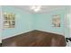 Bright bedroom features hardwood floors, two windows with views, and light-blue walls at 1812 Se 38Th Ave, Ocala, FL 34471