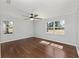 Bedroom featuring hardwood floors, a ceiling fan, and large windows for natural light at 1812 Se 38Th Ave, Ocala, FL 34471