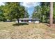 Charming single-story home features brick accents, fresh paint, and mature trees in a lush, green lawn at 1812 Se 38Th Ave, Ocala, FL 34471