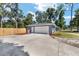 Spacious two-car garage with a clean white door and extended driveway, enhanced by fresh landscaping at 1812 Se 38Th Ave, Ocala, FL 34471