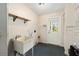 Bright laundry room with utility sink, shelving, and direct access to the backyard at 1812 Se 38Th Ave, Ocala, FL 34471